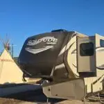 Exterior of RV with Tipi in the background