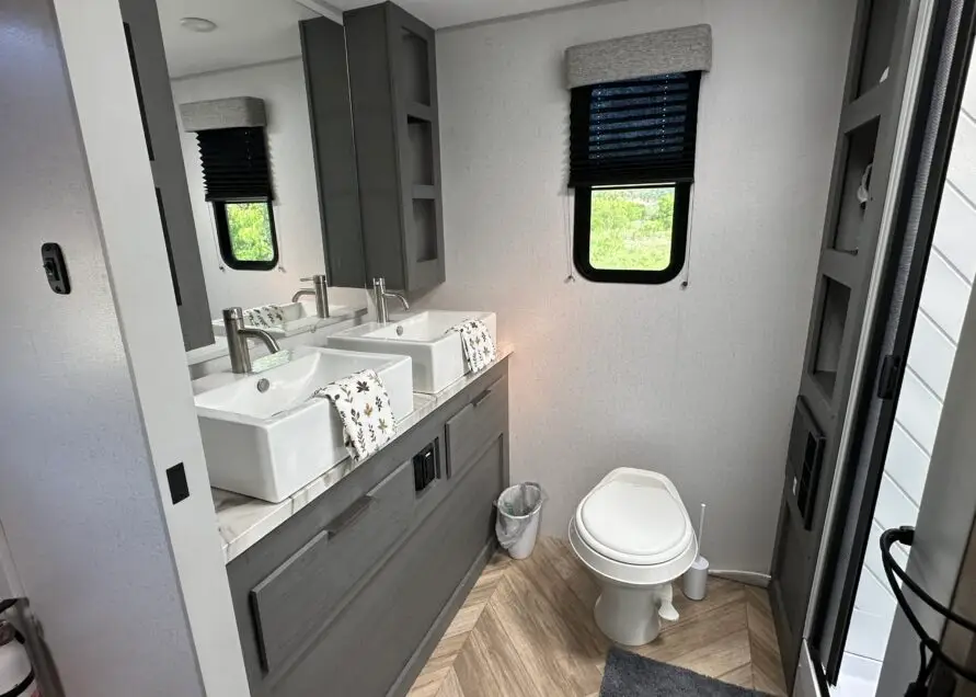 Bathroom with toilet two sinks and mirror