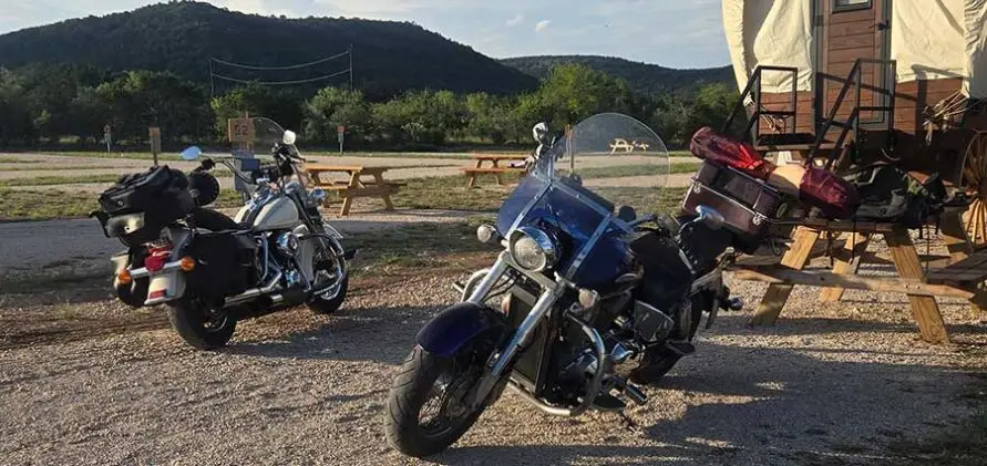 Motorcycles parked at Pitmaster RV Park in Concan, Texas near the Twisted Sisters scenic motorcycle route