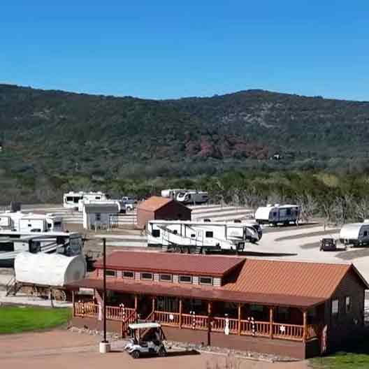 Extended stay RV sites at Pitmaster RV Park in Concan, Texas with full hookups and scenic Texas Hill Country views.