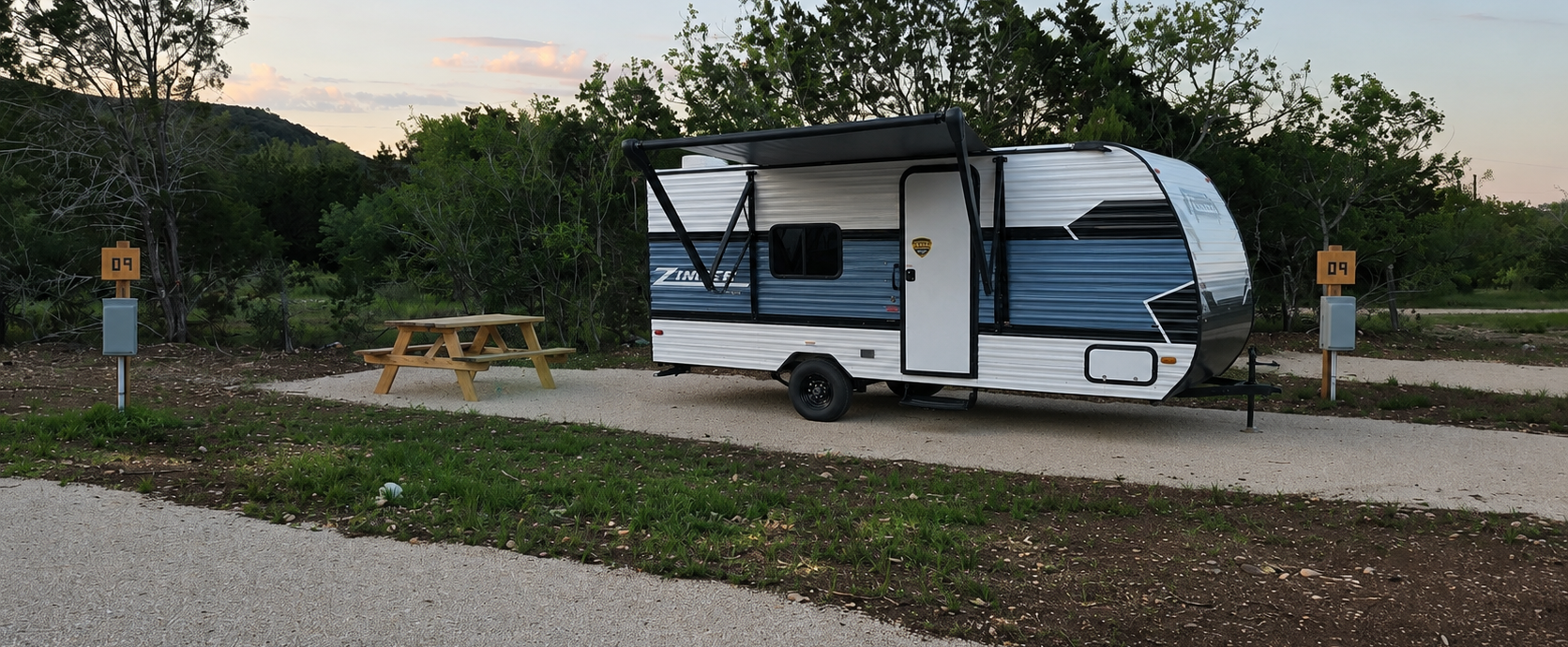 Cozy RV rental with picnic table at Pitmaster RV Park near Garner State Park in Concan, Texas.